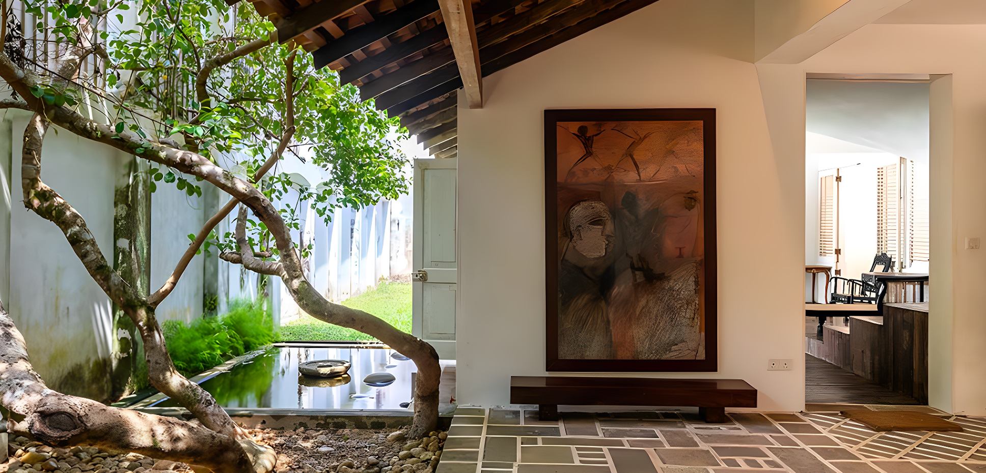 Interior courtyard with a framed artwork installed inside a warm architectural space