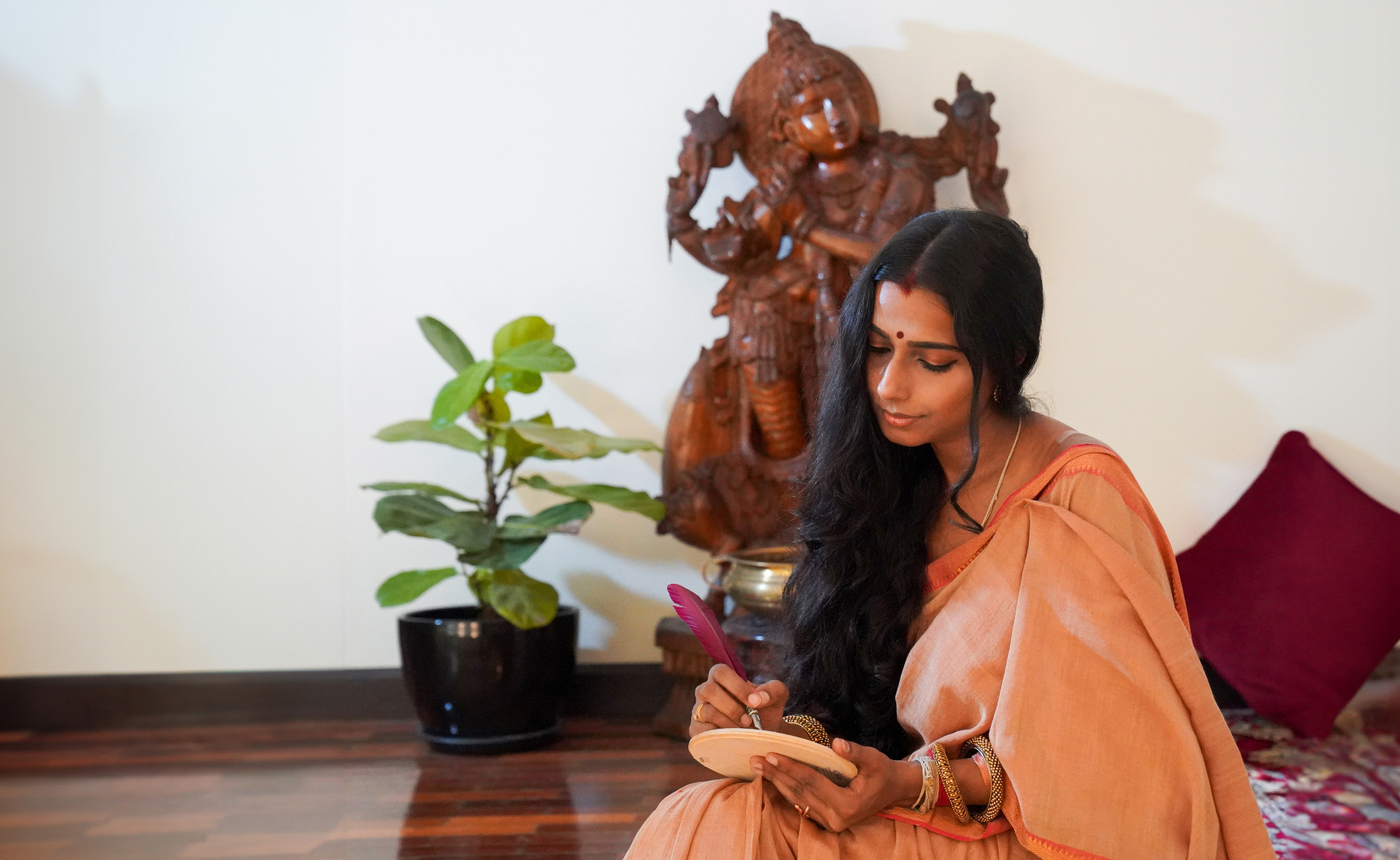 Shantrika writing with a red quill